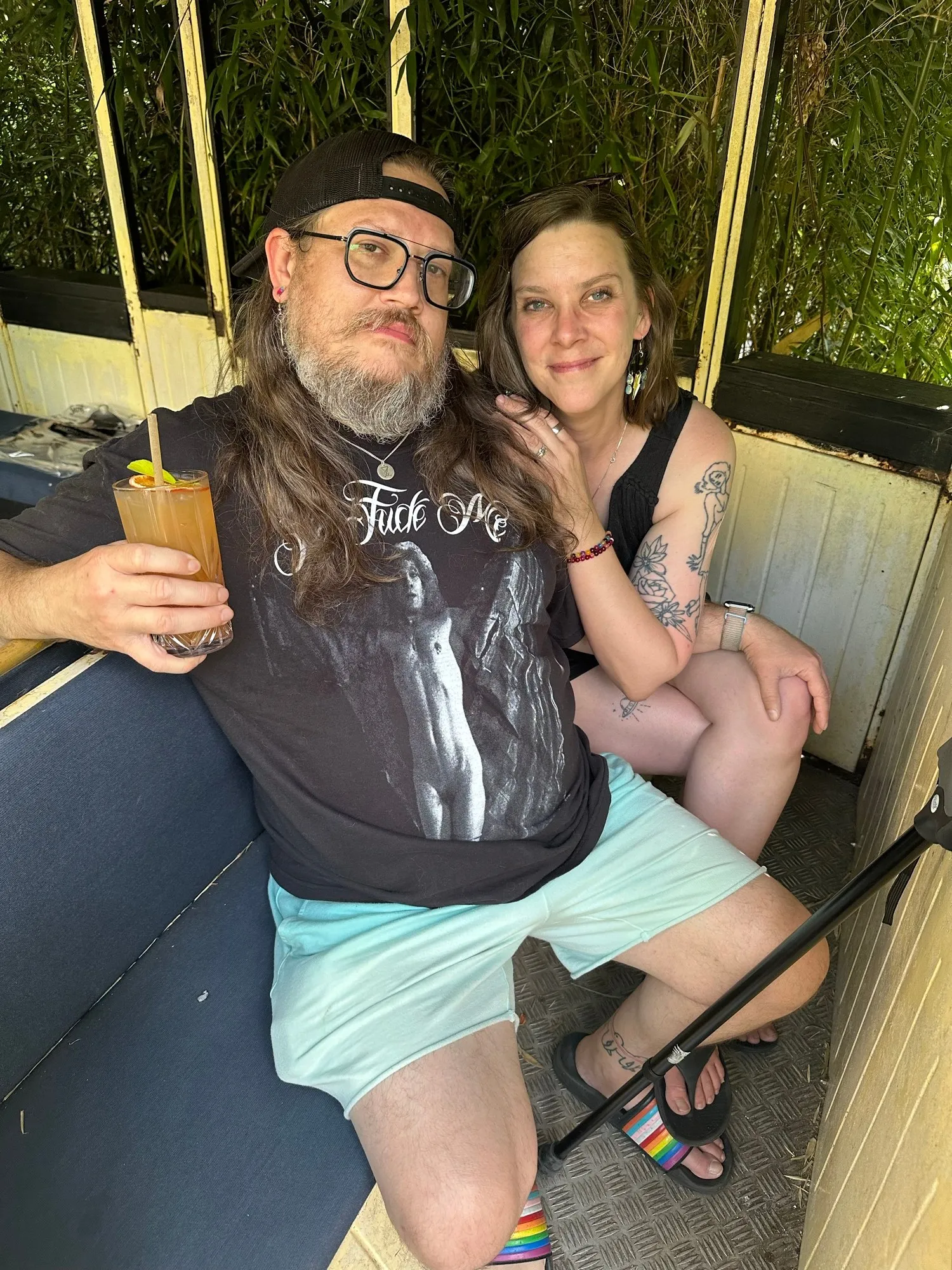 Sitting together on a shaded patio with a cocktail